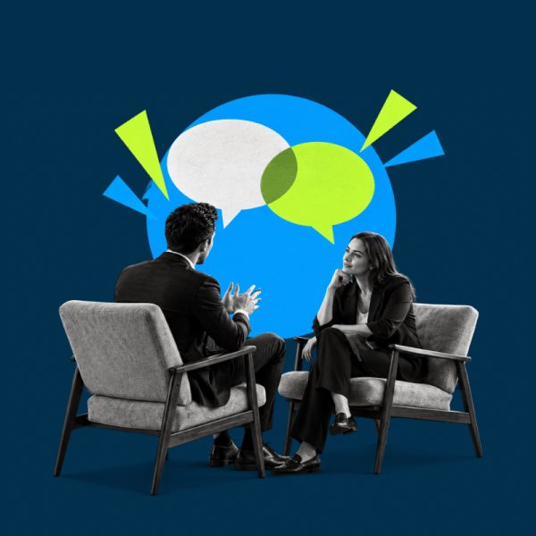 Two professionals sit in armchairs facing each other, talking, with colorful speech bubbles in a blue background behind them.